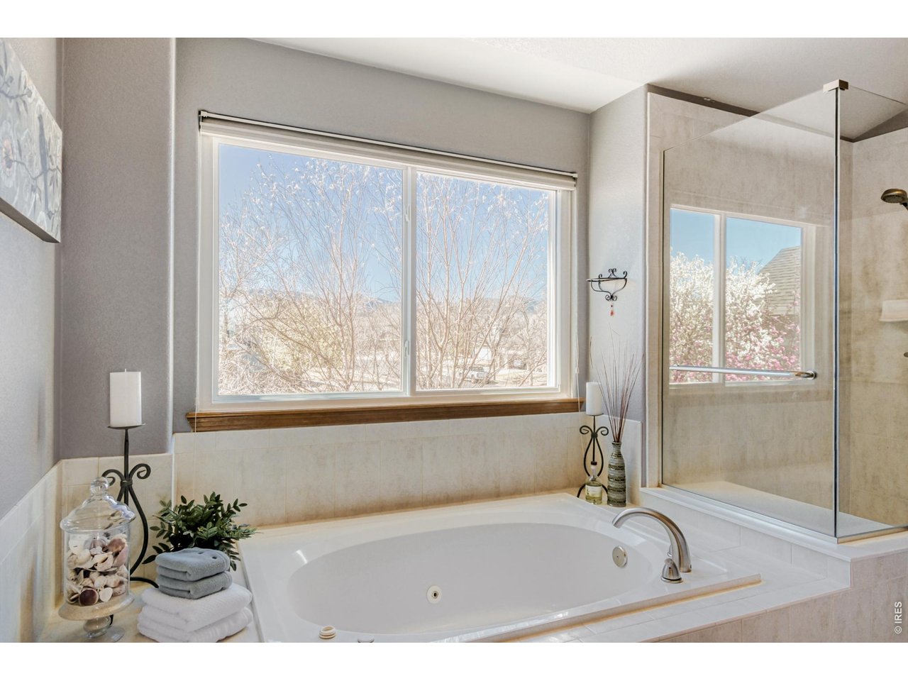 6350 Wier Way Arvada, CO 80403 - Photo 23 of 38 a bathroom with a tub a sink and a large window
