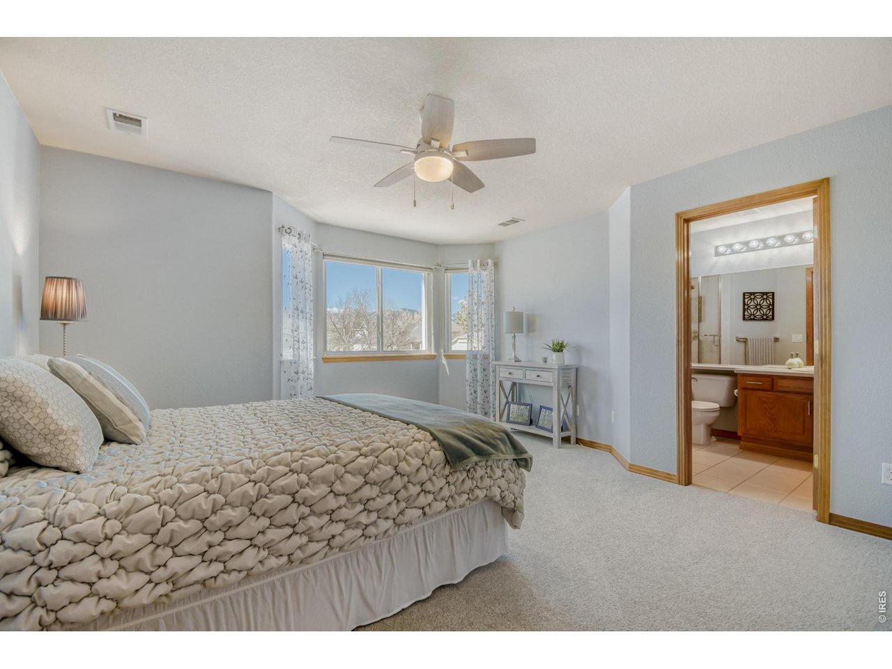 6350 Wier Way Arvada, CO 80403 - Photo 26 of 38 a bedroom with a large bed and a chandelier