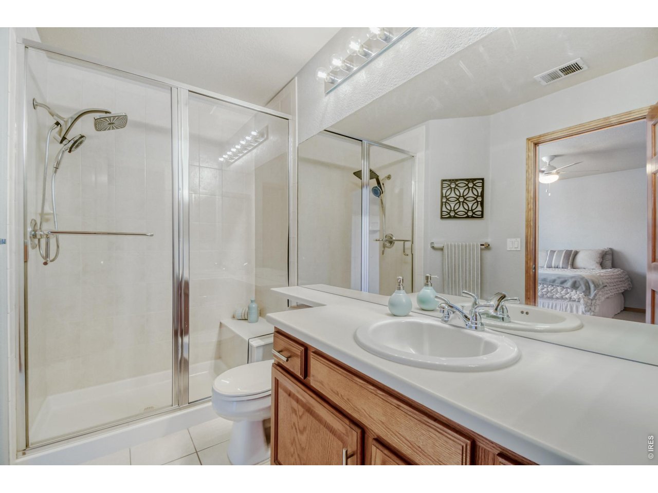6350 Wier Way Arvada, CO 80403 - Photo 27 of 38 a bathroom with a sink toilet a mirror and shower