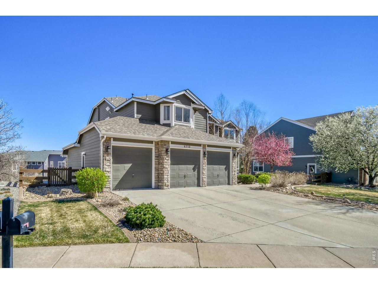 6350 Wier Way Arvada, CO 80403 - Photo 3 of 38 a front view of a house with a yard