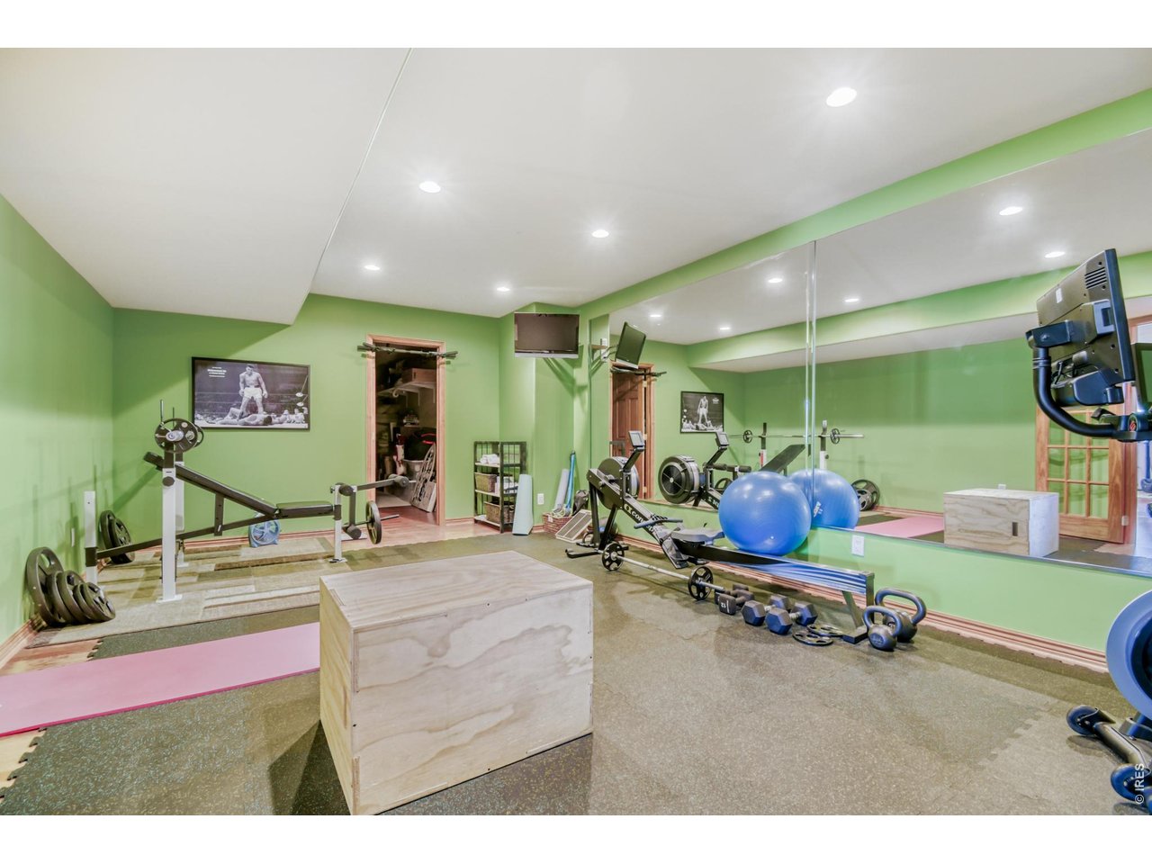 6350 Wier Way Arvada, CO 80403 - Photo 34 of 38 a room with gym equipment and a large mirror