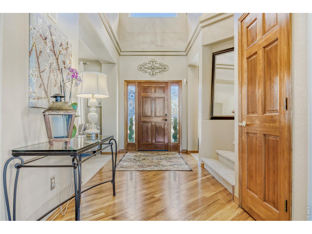 6350 Wier Way Arvada, CO 80403 - Photo 4 of 38 a view of hallway with wooden floor and chair