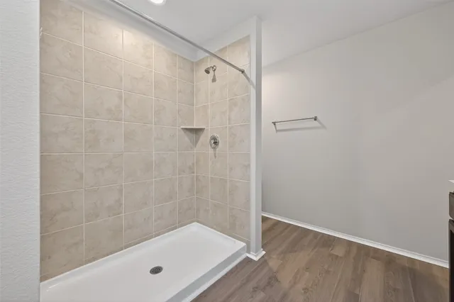 a bathroom with a shower and a bathtub