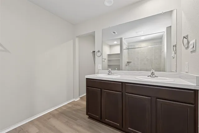 a bathroom with double sink and mirror