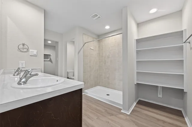 a bathroom with a sink a mirror and shower