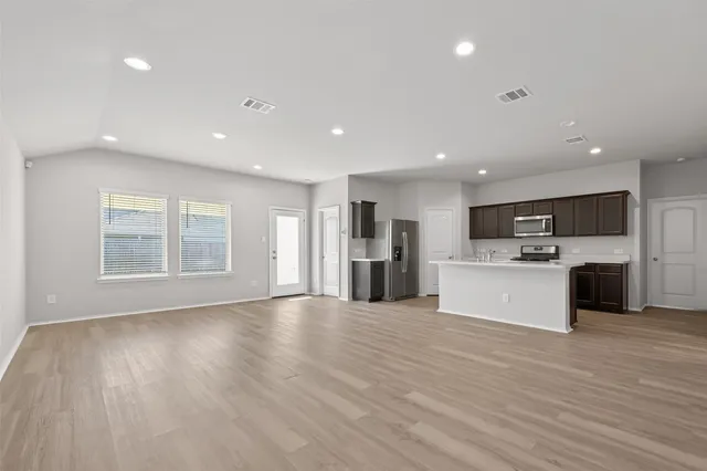 a view of kitchen with cabinets microwave and stove