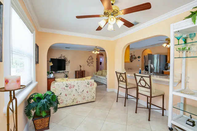a bedroom with furniture and a large window