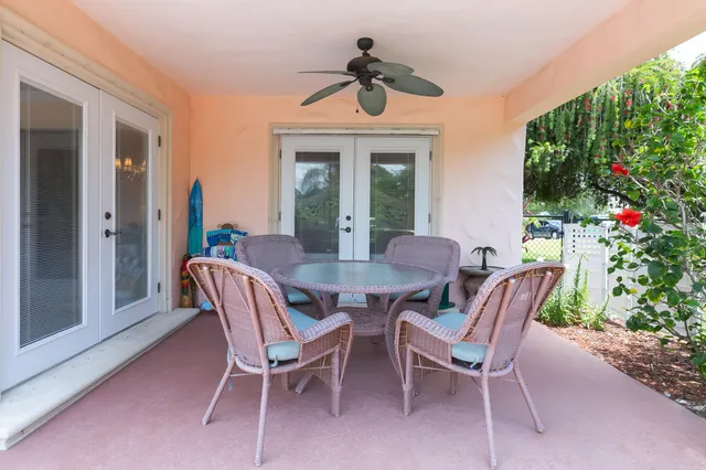 a view of a house with backyard and sitting area
