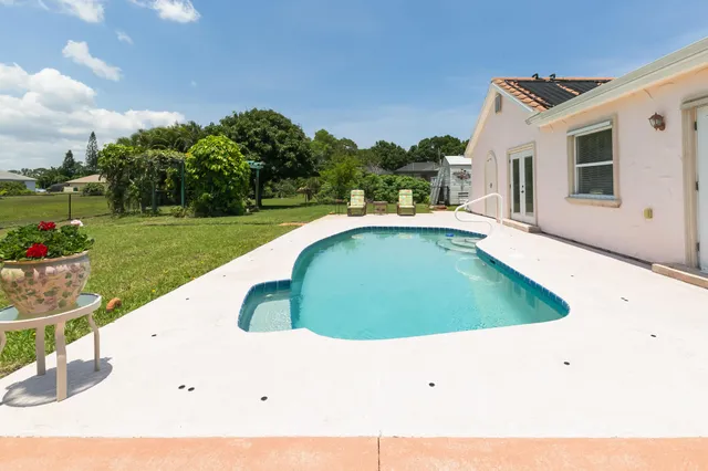 a view of a swimming pool with a yard
