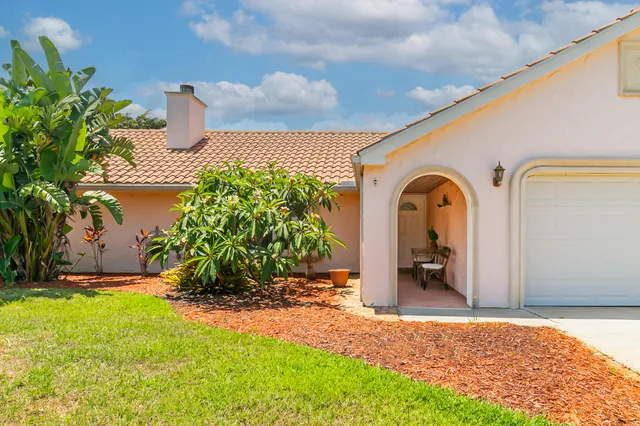 a front view of a house with garden