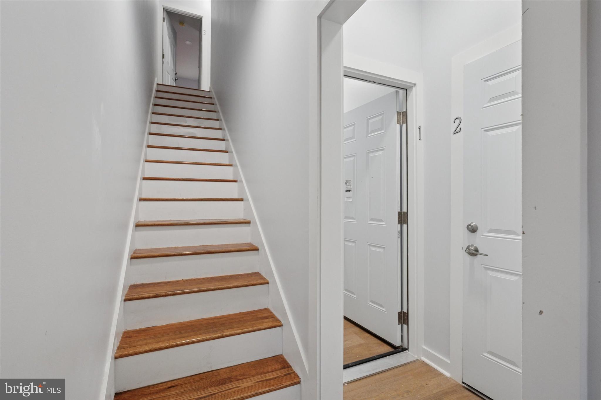 251 South 44th Street, Unit 2 Philadelphia, PA 19104 - Photo 3 of 12 a view of a hallway with wooden floor and entryway