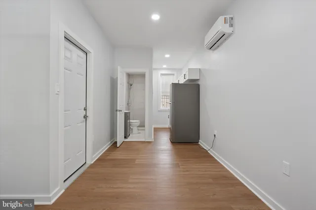 a view of a hallway with wooden shelves