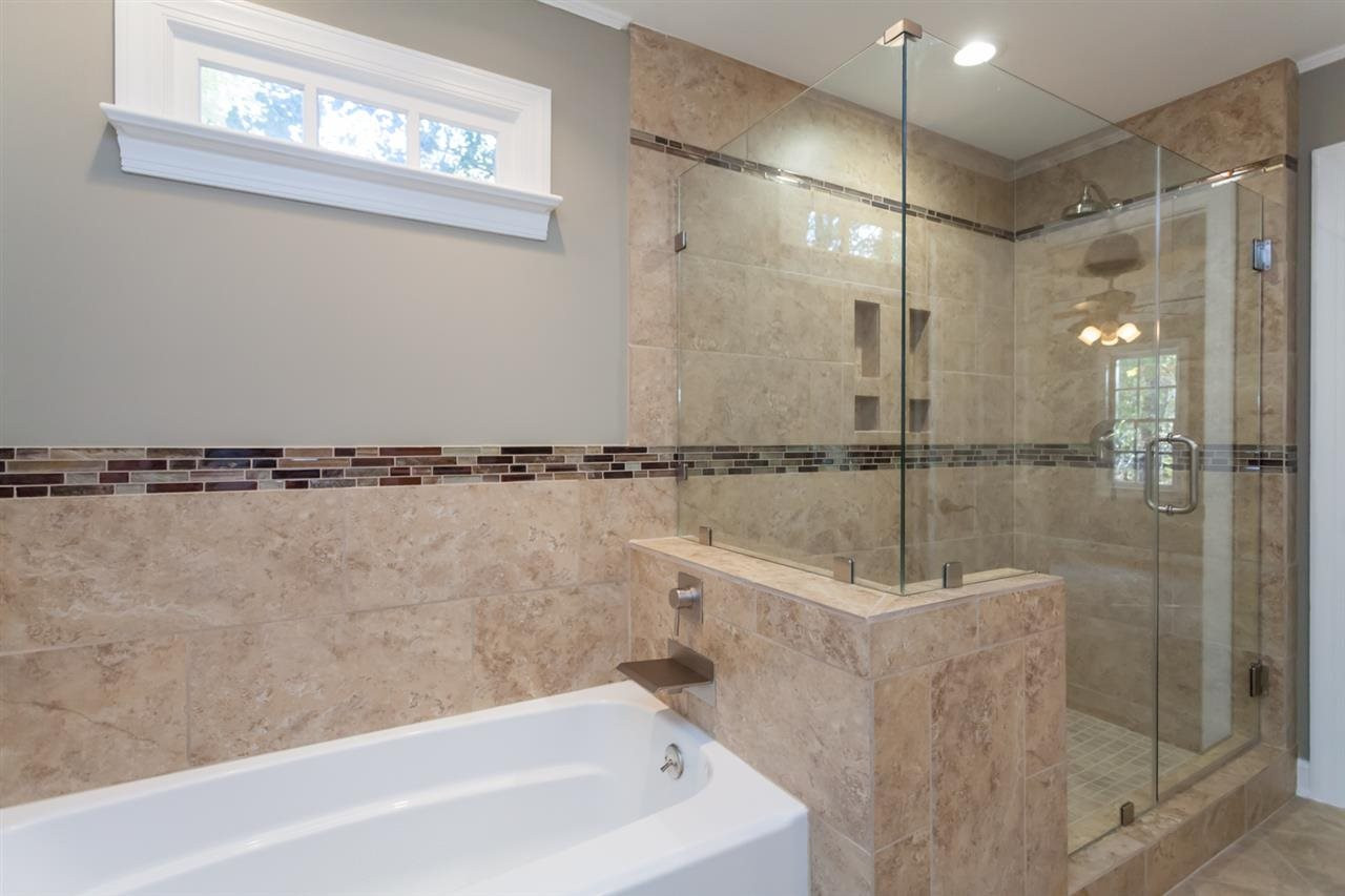 5516 North Hawthorne Park Raleigh, NC 27613 - Photo 14 of 25 Seamless doors, waterfall shower head & glass deco accents give this bath a custom feel and look