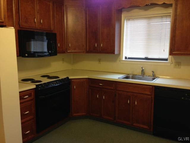 853 Cold Spring Road Allentown, PA 18103 - Photo 11 of 27 a kitchen with granite countertop wooden cabinets and a stove top oven