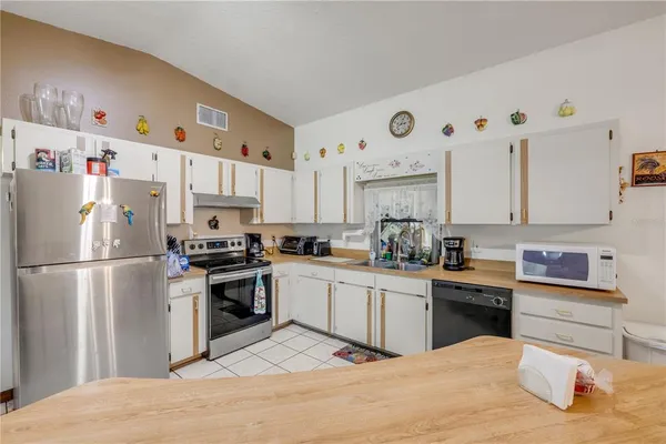a large white kitchen with cabinets
