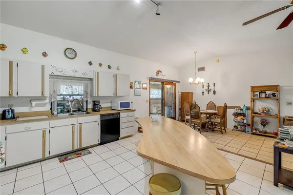 a kitchen with stainless steel appliances a sink a stove and white cabinets