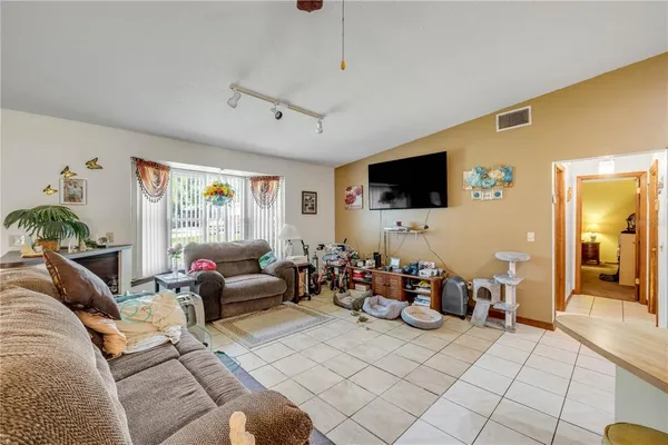 a bedroom with furniture and a large window