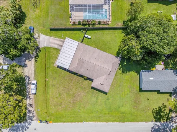 an aerial view of residential house with outdoor space and swimming pool