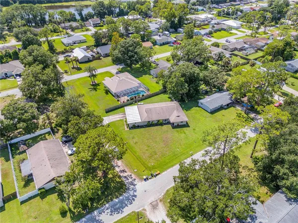 an aerial view of residential houses with outdoor space and swimming pool