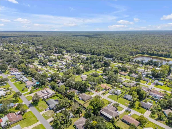 an aerial view of residential building with green space