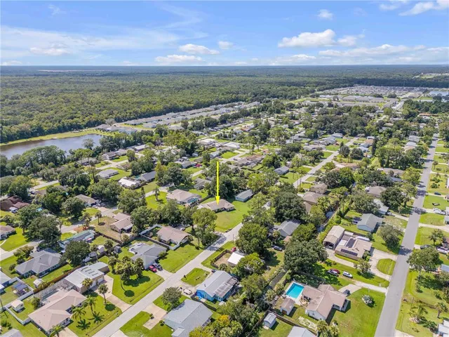 an aerial view of residential building with green space