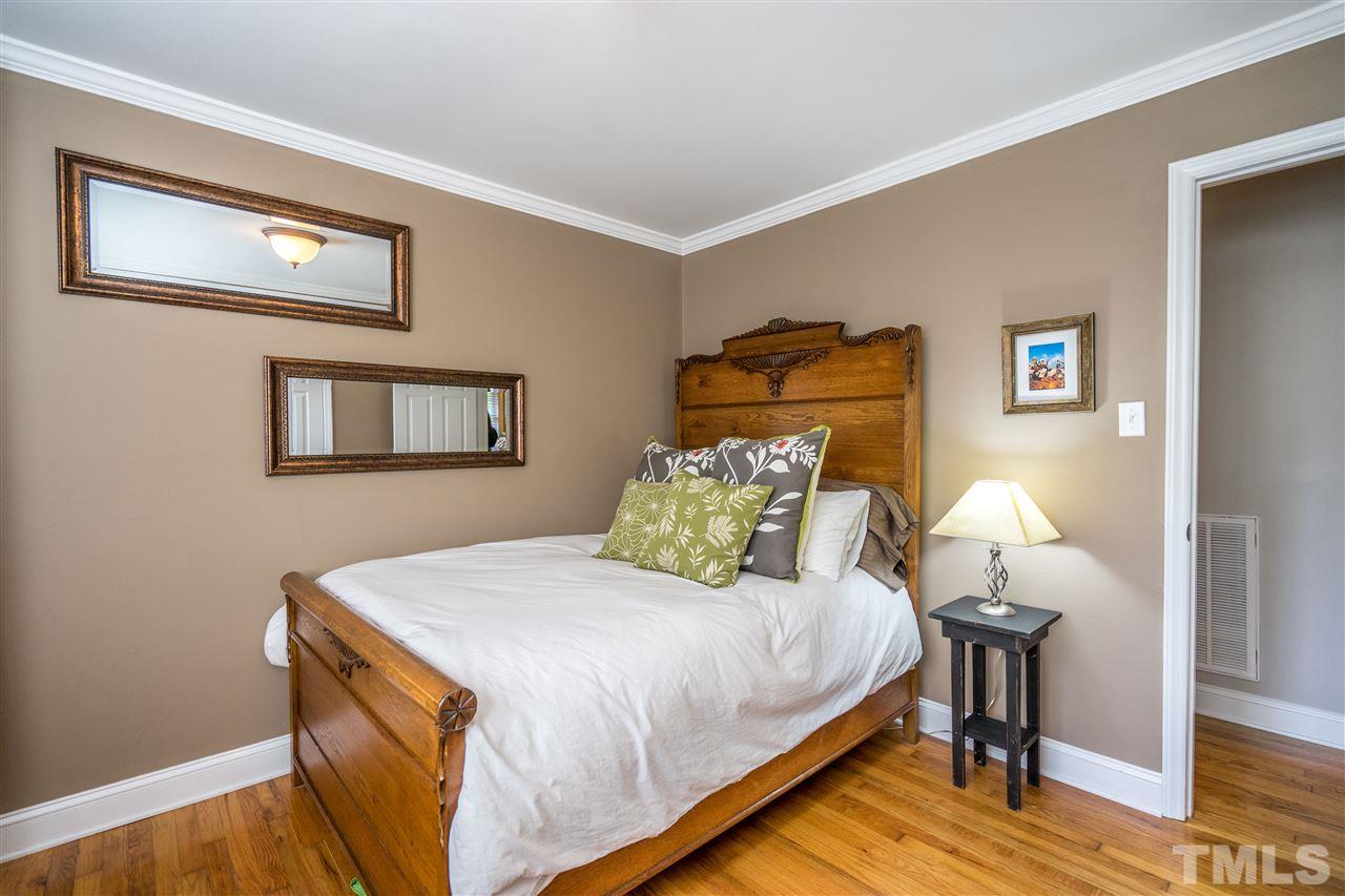 539 Banks Street Raleigh, NC 27604 - Photo 22 of 25 a bedroom with a bed and a lamp on table