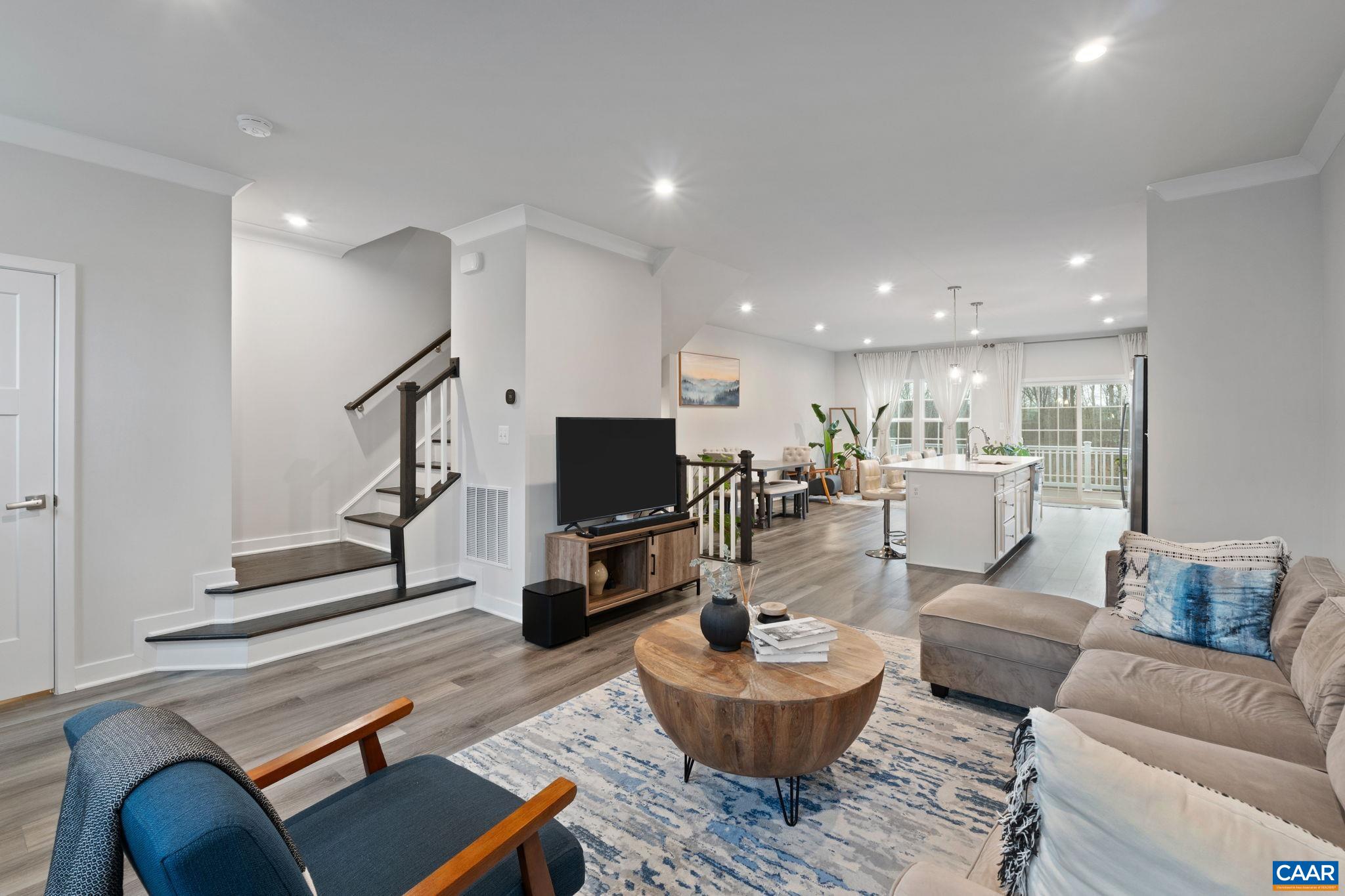 2402 Crescent Way Charlottesville, VA 22911 - Photo 12 of 27 Bright open-concept main level featuring spacious living area flowing seamlessly into kitchen and dining, ideal for everyday living and entertaining.