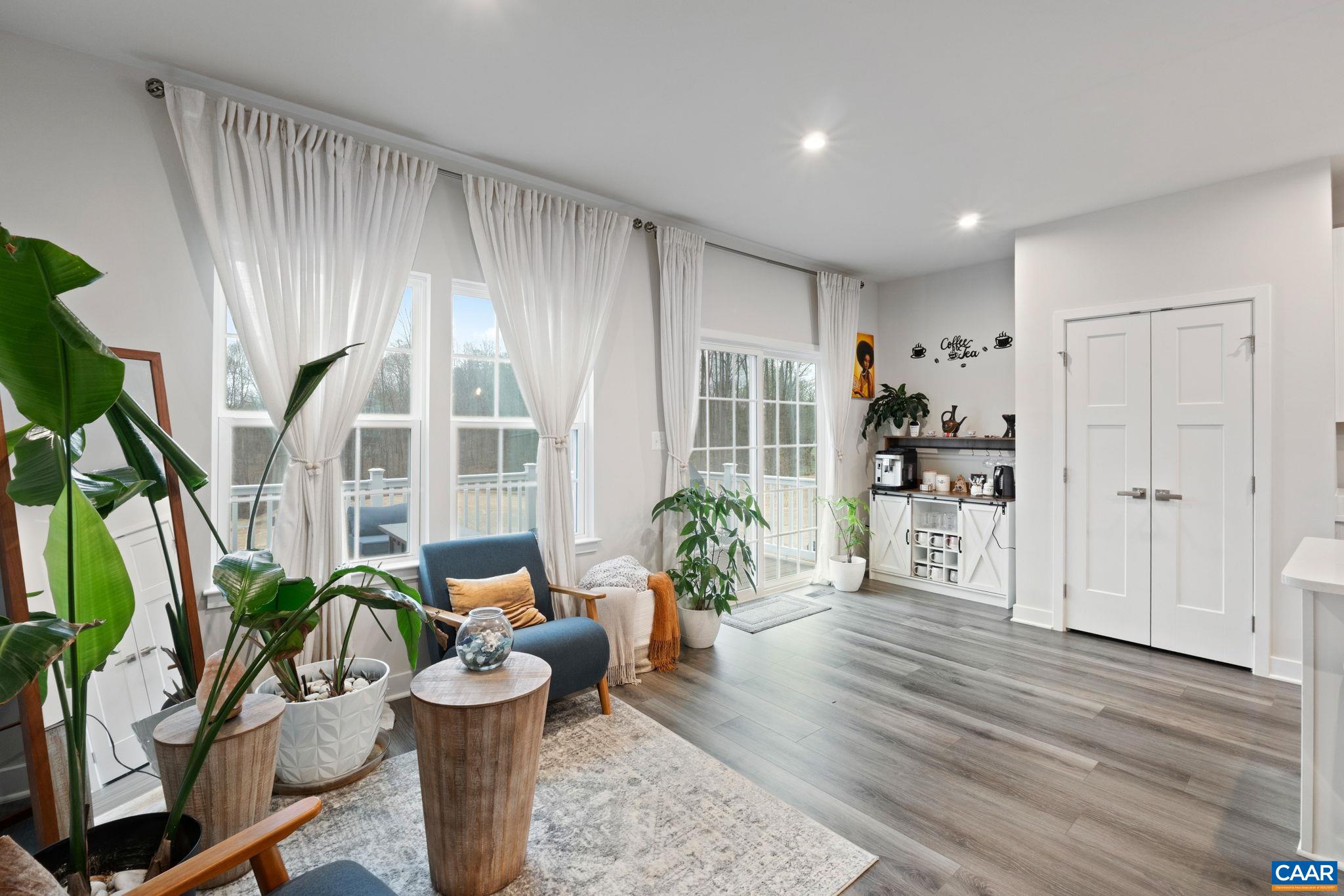 2402 Crescent Way Charlottesville, VA 22911 - Photo 18 of 27 Bright dining area with large windows, abundant natural light, and direct access to the rear deck—creating an inviting space for everyday meals and indoor-outdoor living.