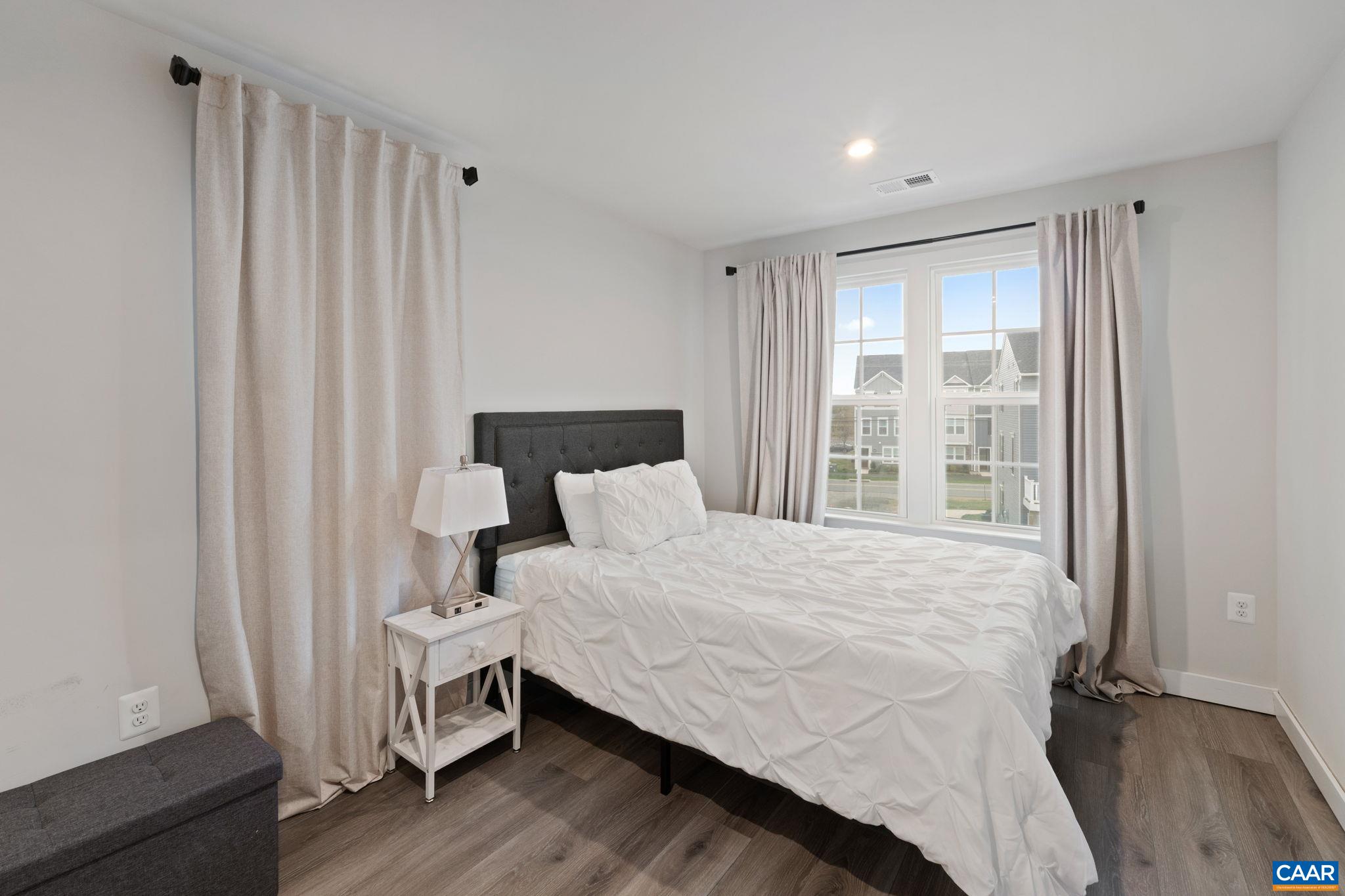 2402 Crescent Way Charlottesville, VA 22911 - Photo 20 of 27 Comfortable third-floor bedroom featuring ample natural light, neutral finishes, and a functional layout—ideal for guests, family, or a home office.