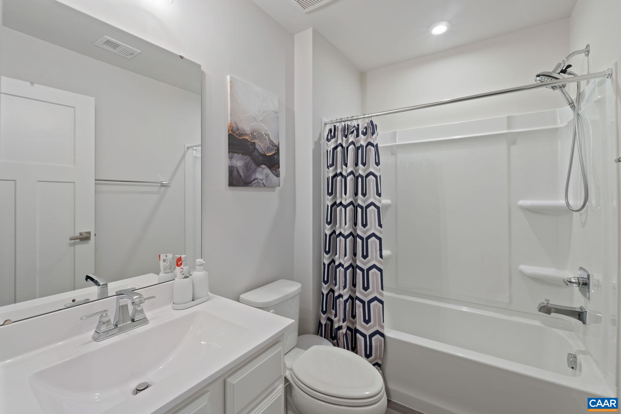 2402 Crescent Way Charlottesville, VA 22911 - Photo 21 of 27 Clean and modern full bathroom featuring a tub/shower combo, single vanity, and bright neutral finishes—well-suited for guests or everyday use.