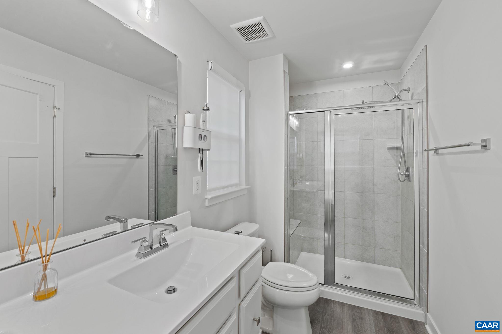 2402 Crescent Way Charlottesville, VA 22911 - Photo 24 of 27 Spacious primary bathroom featuring dual vanities, soaking tub, and separate glass-enclosed shower—designed for comfort and everyday functionality.