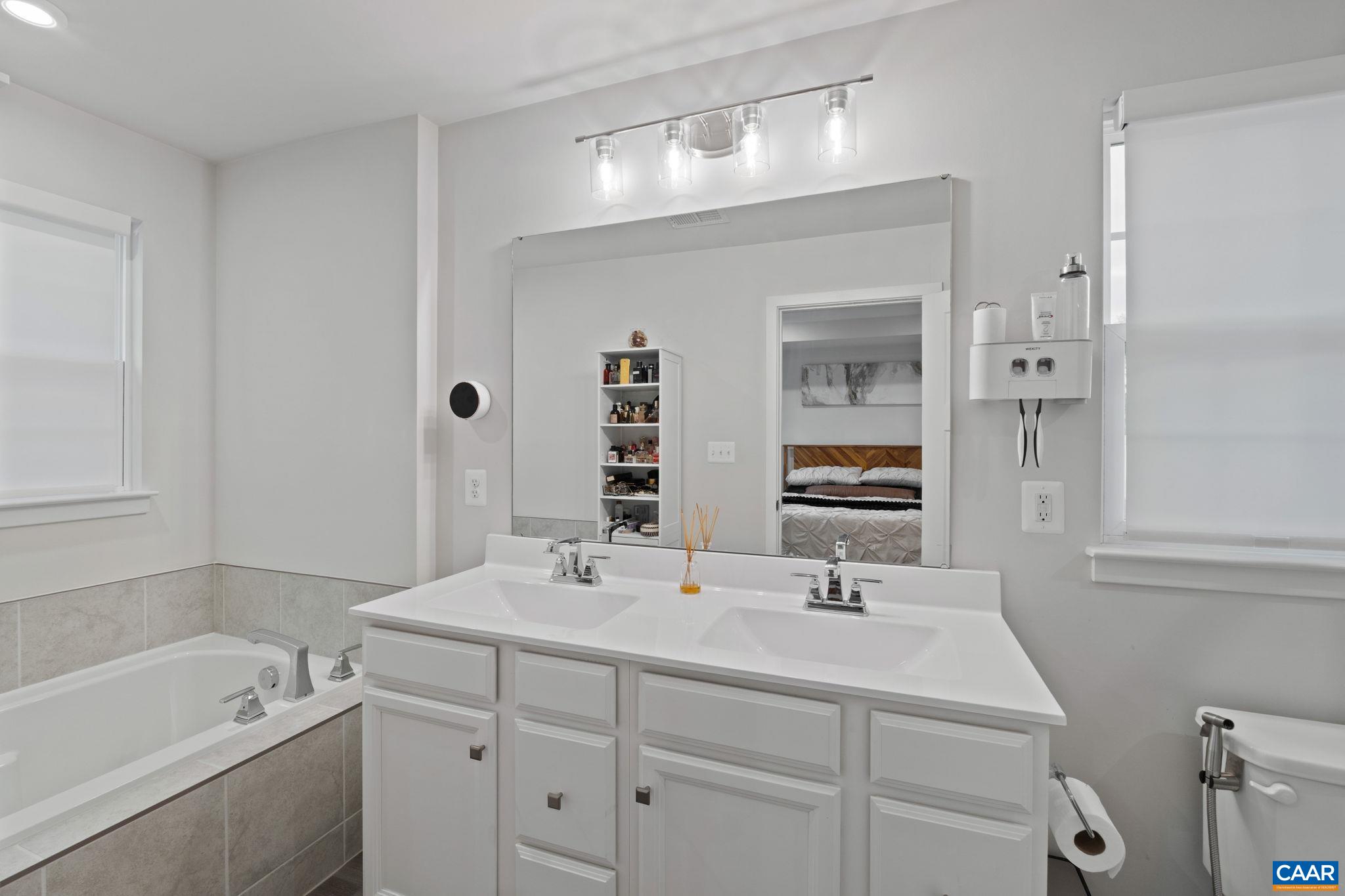 2402 Crescent Way Charlottesville, VA 22911 - Photo 25 of 27 Alternate view of the primary bath highlighting double vanity layout, modern fixtures, and a bright, clean design with both tub and walk-in shower.