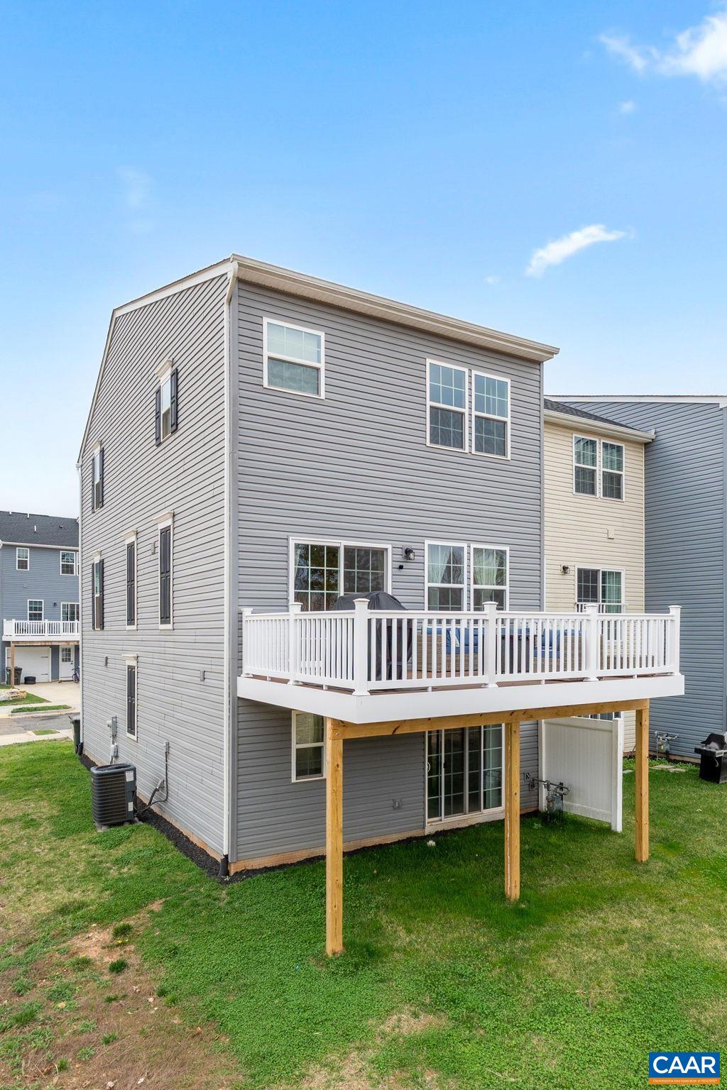 2402 Crescent Way Charlottesville, VA 22911 - Photo 4 of 27 Spacious rear deck overlooking a private backyard, perfect for outdoor entertaining or relaxing. Elevated design provides added privacy with access to lower-level patio area. Low-maintenance exterior with vinyl siding.