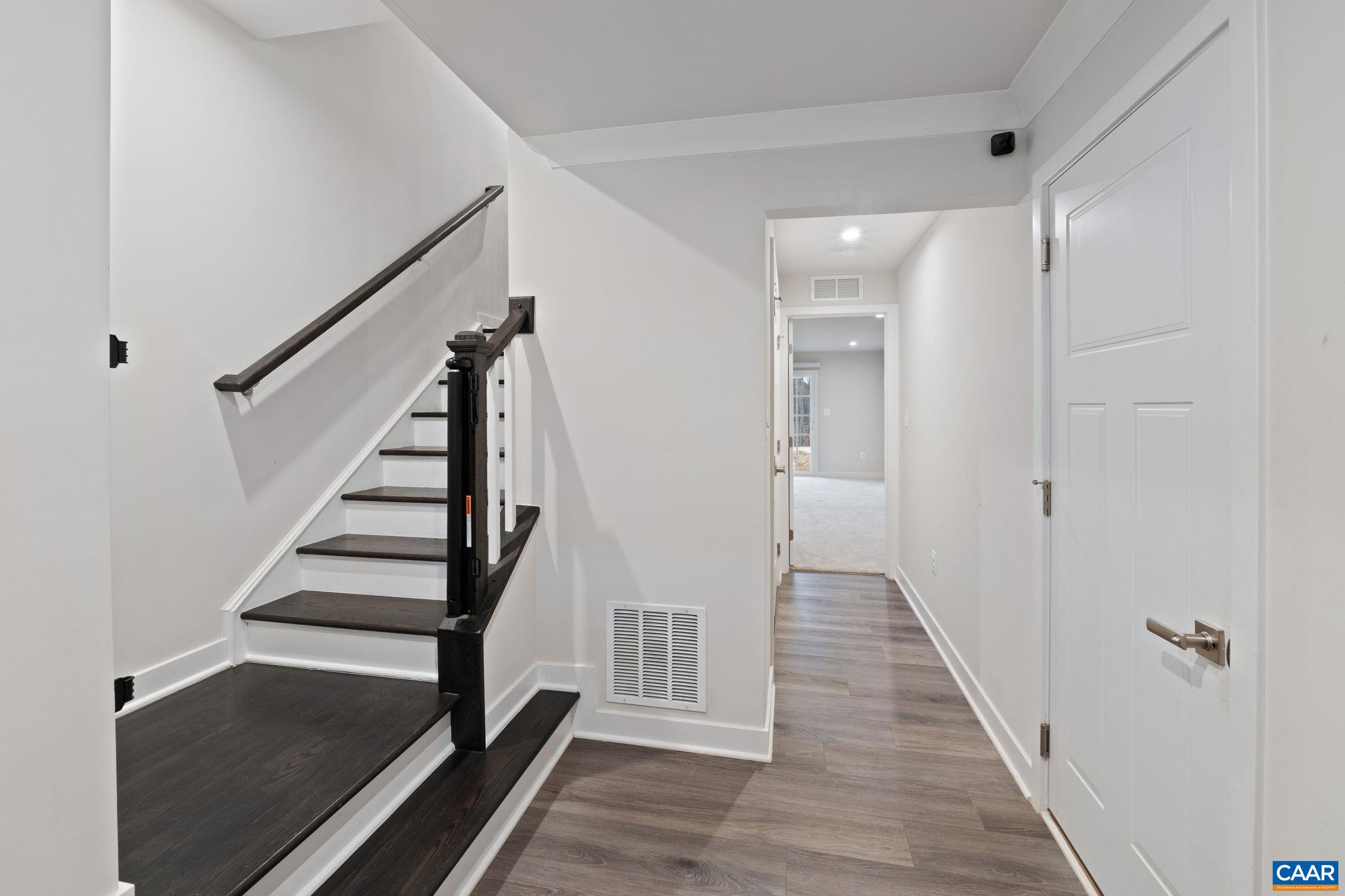 2402 Crescent Way Charlottesville, VA 22911 - Photo 6 of 27 Entry-level foyer with modern flooring, staircase to main living area, and access to additional living space. Clean, open layout with contemporary finishes.