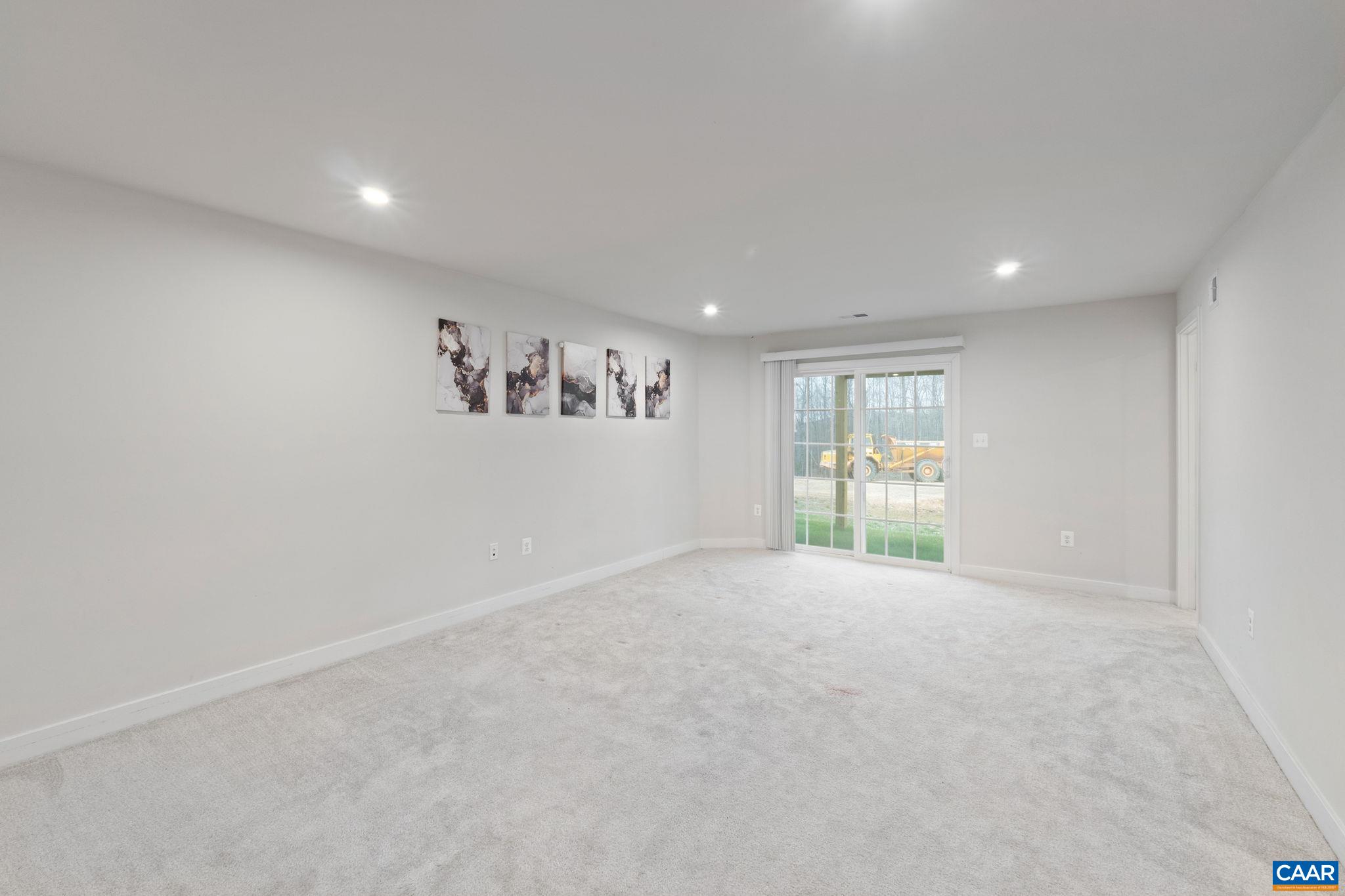 2402 Crescent Way Charlottesville, VA 22911 - Photo 7 of 27 Spacious entry-level room with plush carpet, access to full bath, and walk-in closet—ideal for guest suite, office, or additional living space.