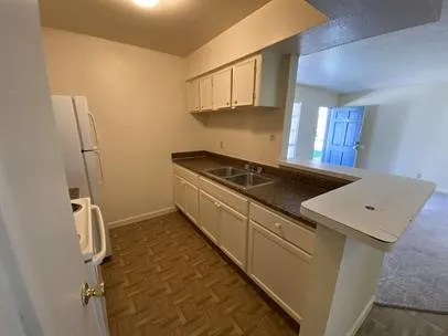 a kitchen with a stove and a refrigerator