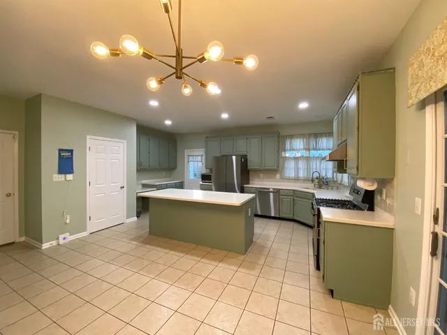 a kitchen with stainless steel appliances granite countertop a sink counter space cabinets and a window