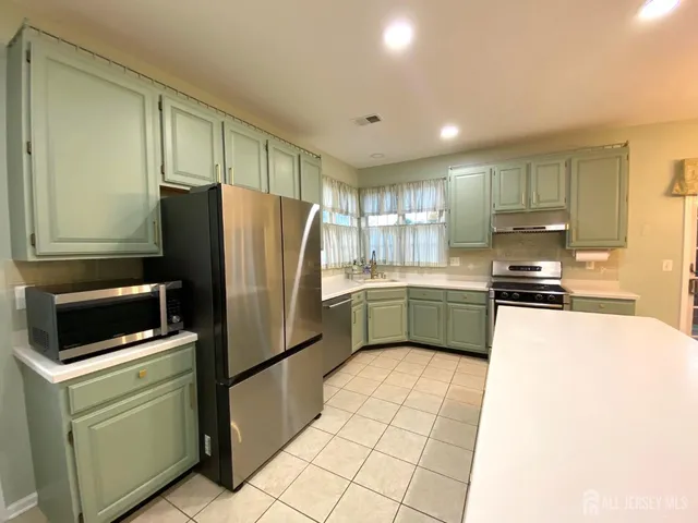 a kitchen with a refrigerator sink and microwave
