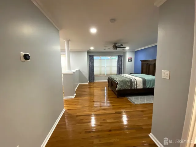a bedroom with a bed and a view of en suite bathroom