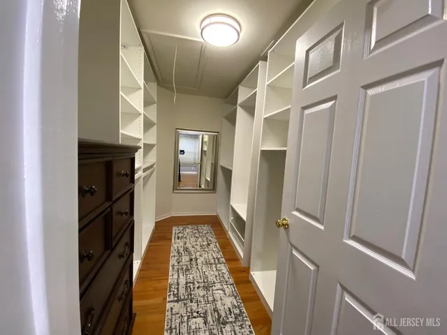 a view of hallway with wooden floor and staircase
