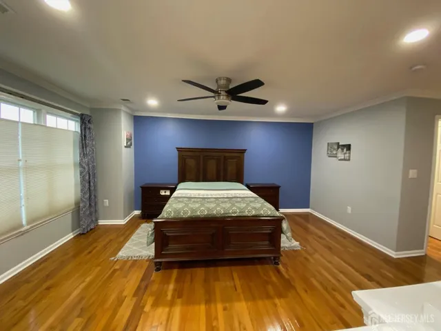a bedroom with a bed and a ceiling fan