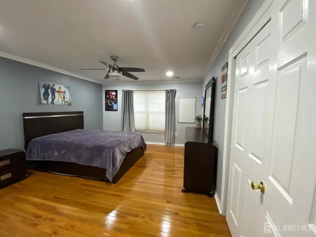 a spacious bedroom with a bed and a chandelier