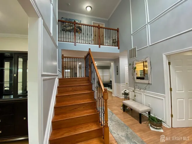 a view of entryway and hall with wooden floor
