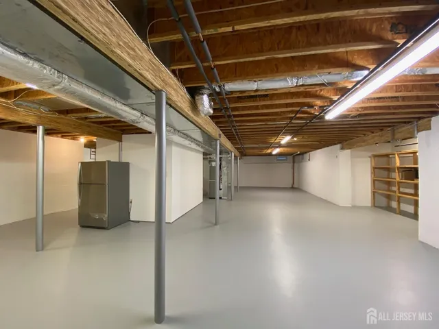 a view of an empty room with a refrigerator