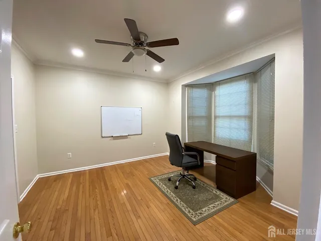 a workspace with wooden floor and windows