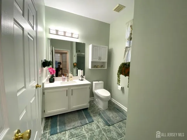 a bathroom with a sink and mirror with toilet