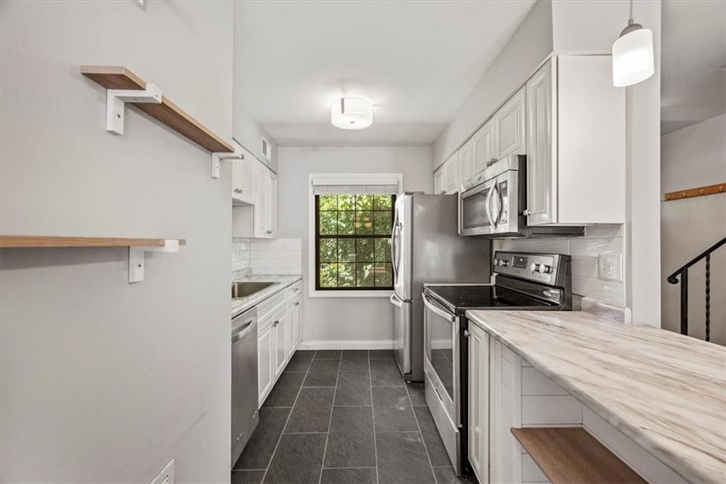 428 Country View Court Pittsburgh, PA 15205 - Photo 11 of 28 a kitchen with a sink a stove cabinets and a window