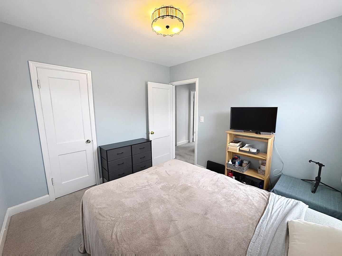 509 40th Street East Moline, IL 61244 - Photo 13 of 23 a bedroom with a bed and a tv on a dresser