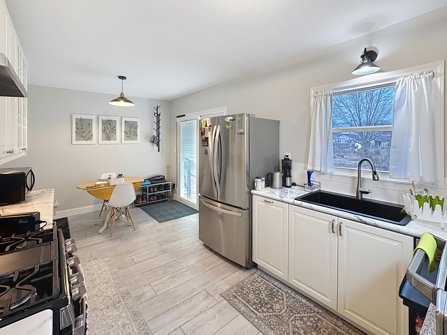 509 40th Street East Moline, IL 61244 - Photo 8 of 23 a kitchen with stainless steel appliances granite countertop a sink and a refrigerator