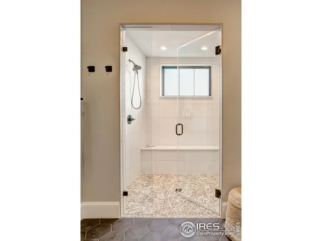 a view of a bathroom with a shower and a mirror